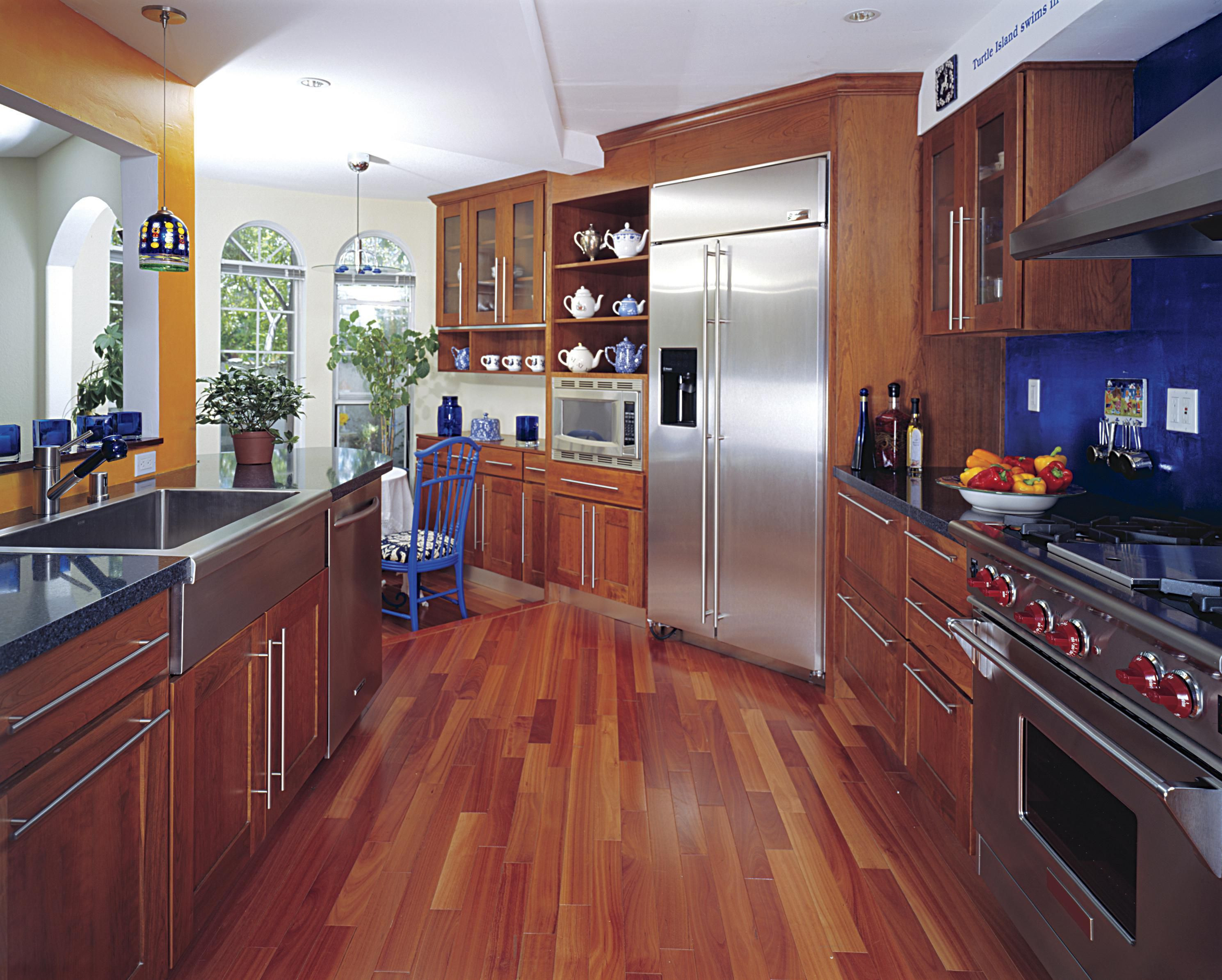 light wood floor in kitchen with dark cabinet